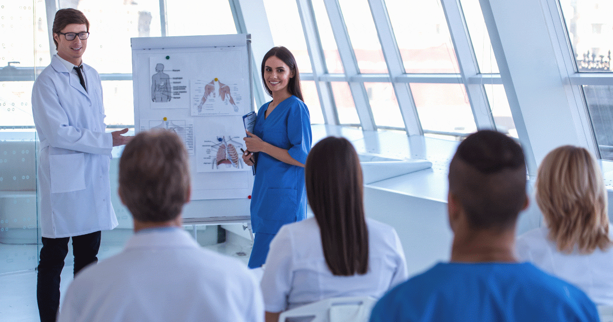 Team of healthcare professionals being trained at a whiteboard