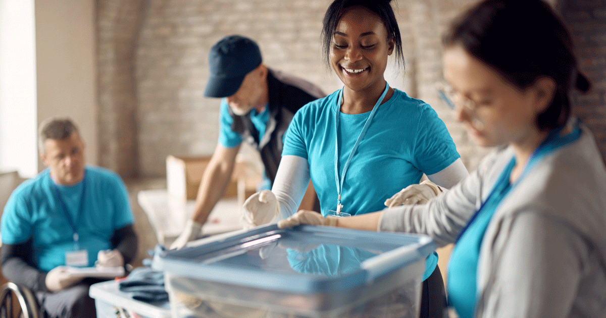 Nurse volunteering with box moving