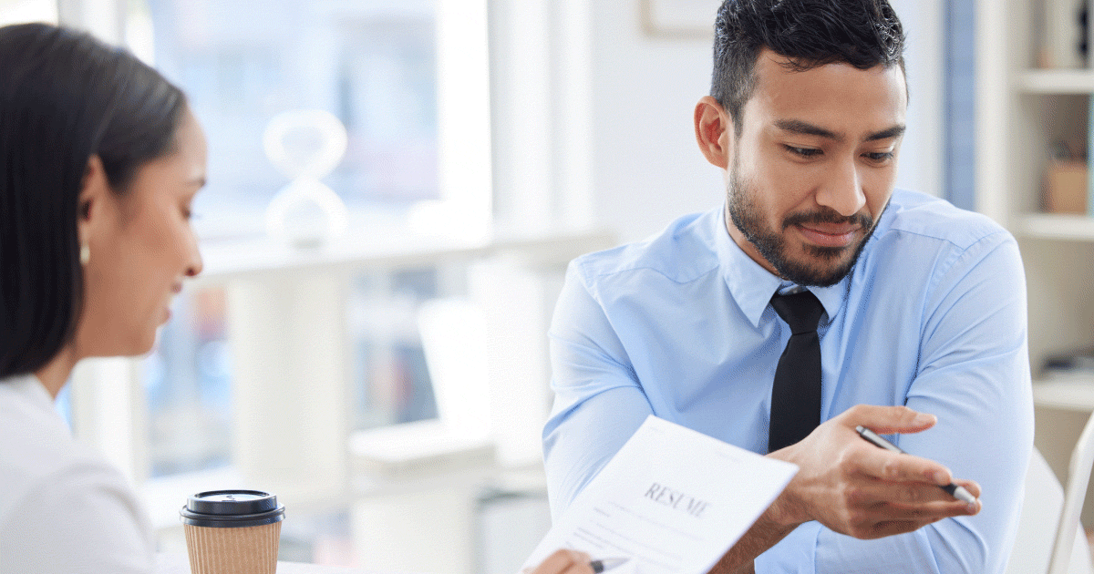 Man advising woman on her CV