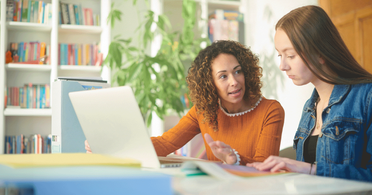 Two women looking at a laptop