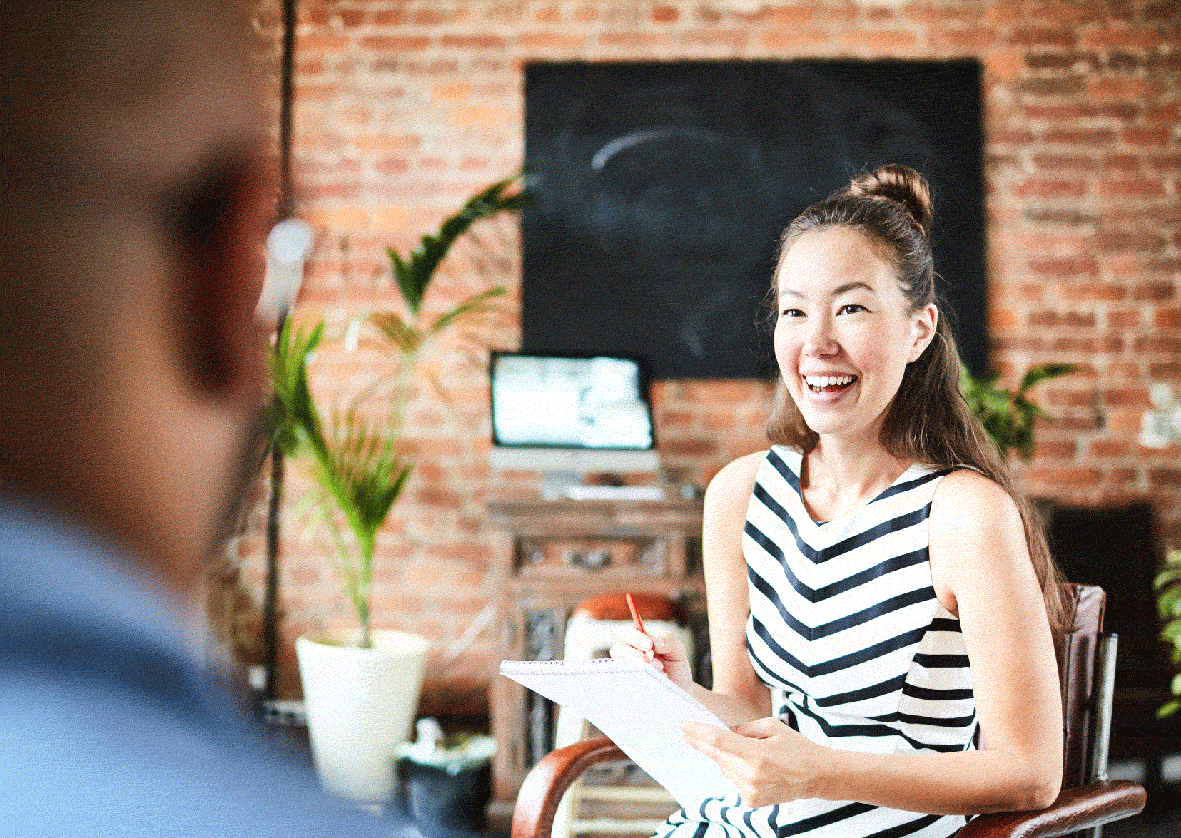 Lady smiling with person in the foreground