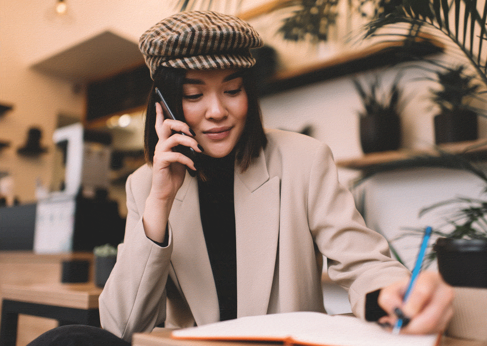 Woman on the phone being interviewed. Pad of paper in front of her.