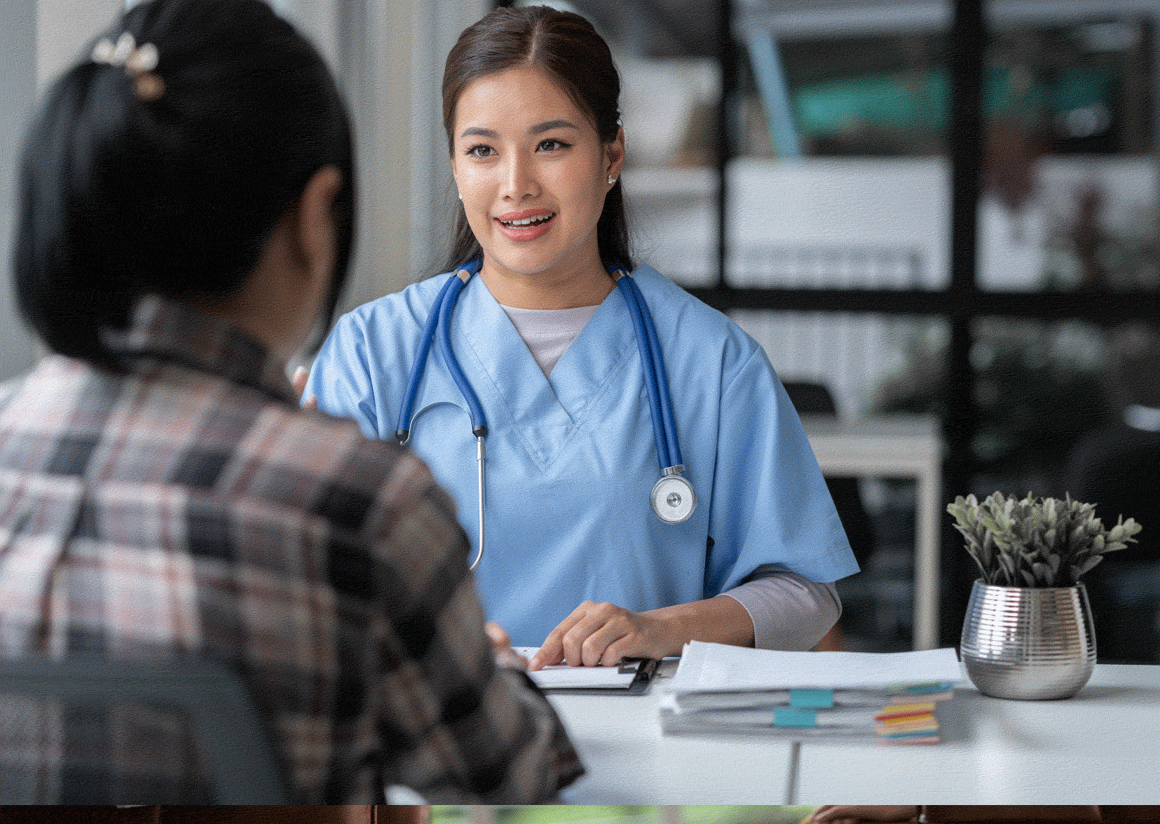 Nurse in scrubs being interviewed