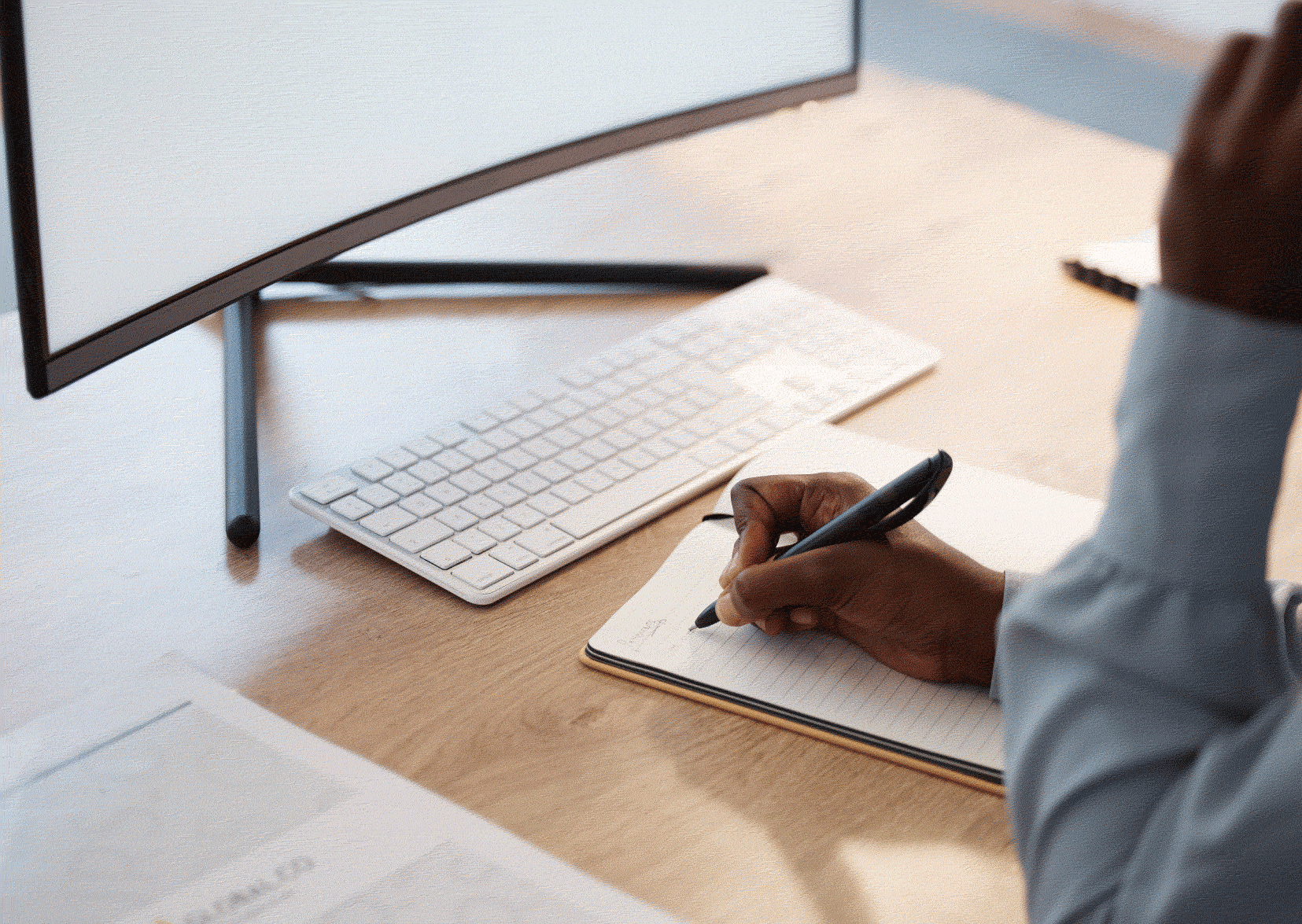 Man in front of laptop with paperwork