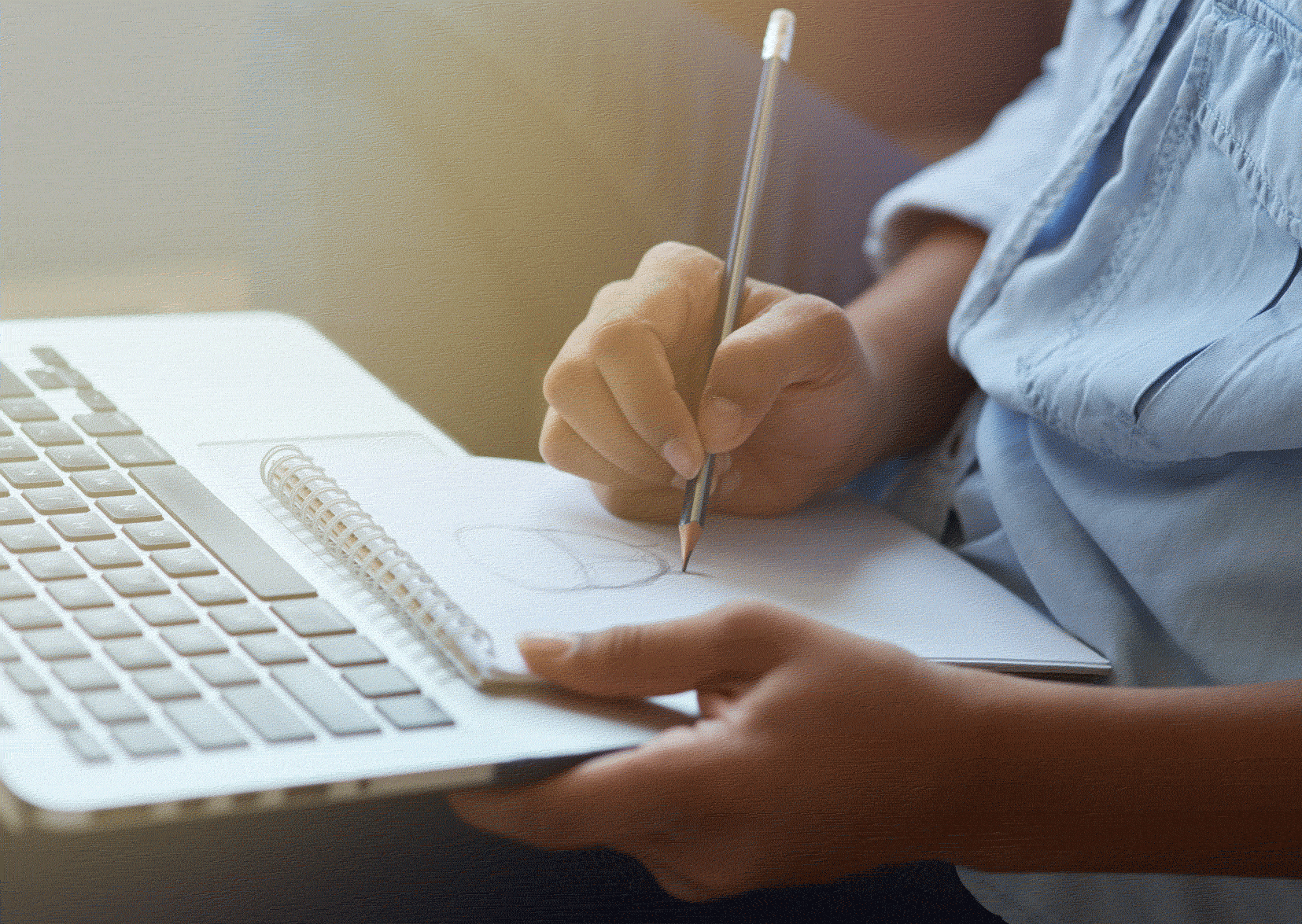 Man in front of laptop with paperwork