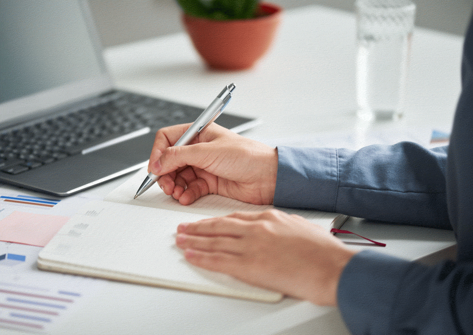 Man in front of laptop with paperwork preparing for interview