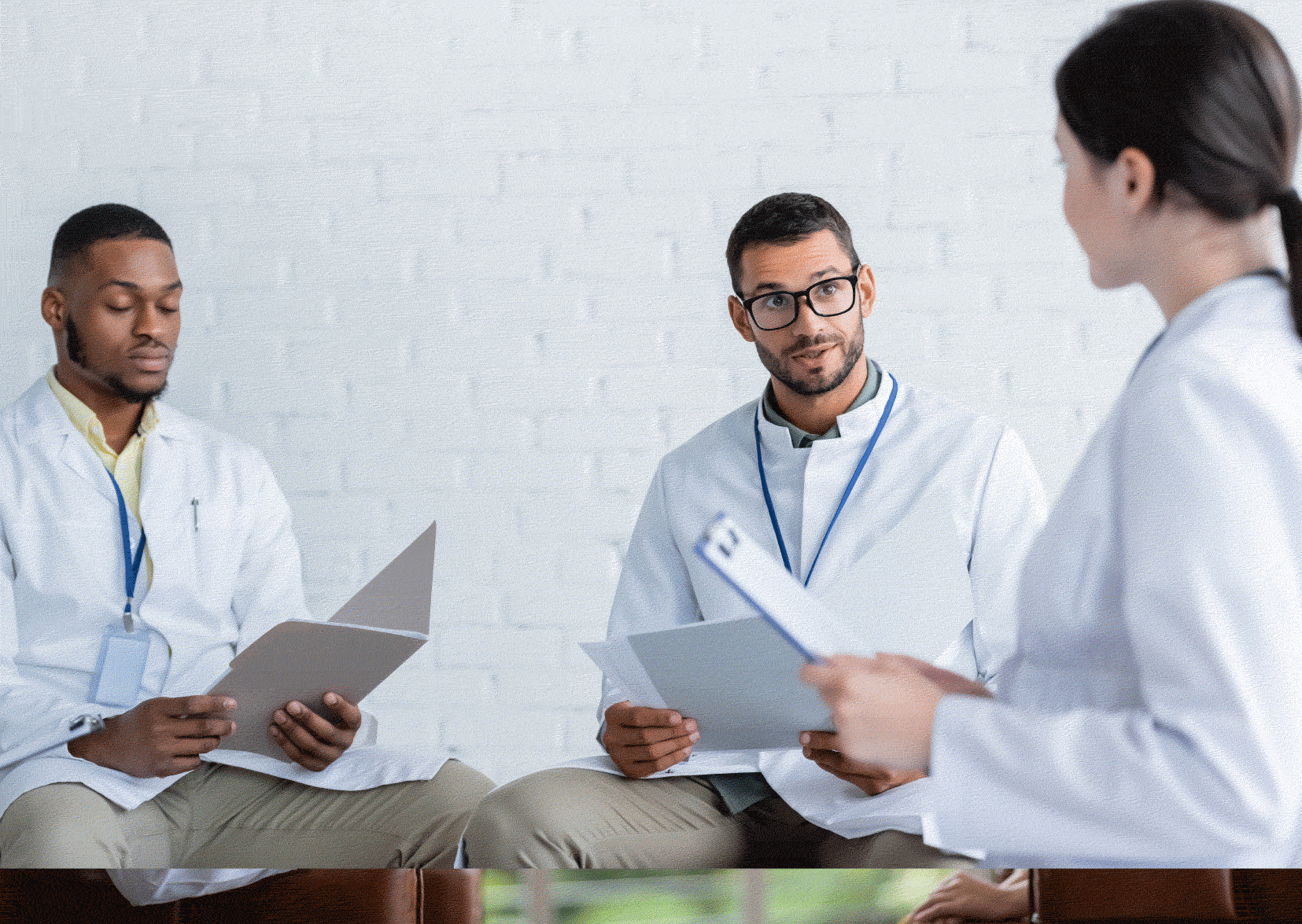 Female nurse being interviewed by two nurses