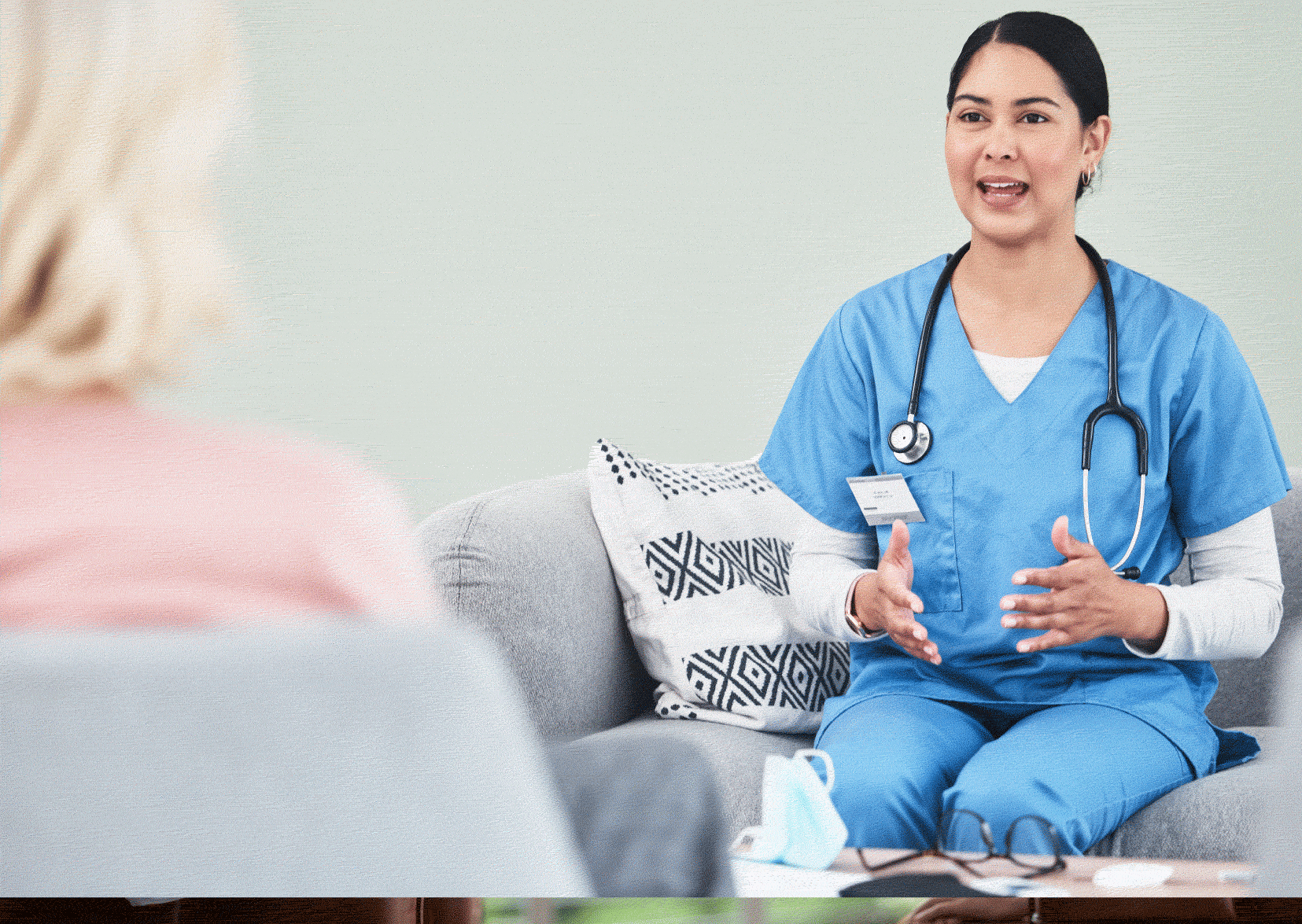 Nurse in scrubs being interviewed