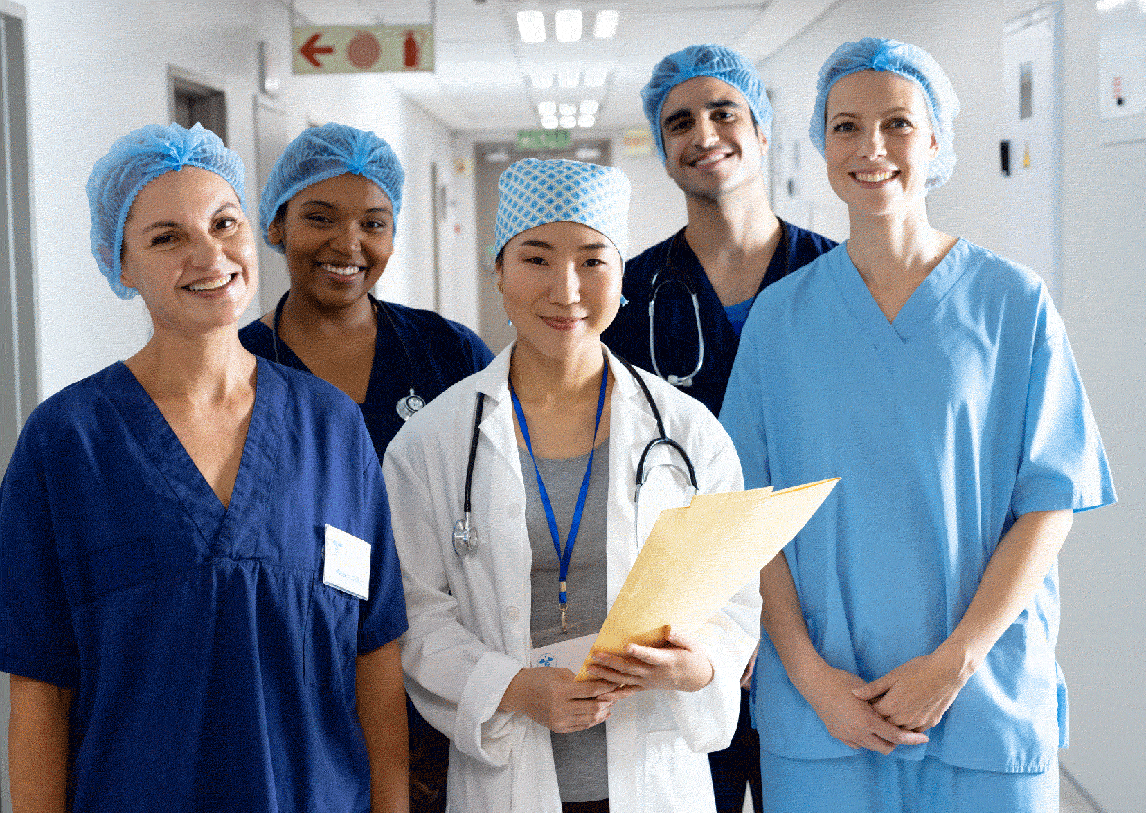 Team of different nurses in multiple coloured scrubs