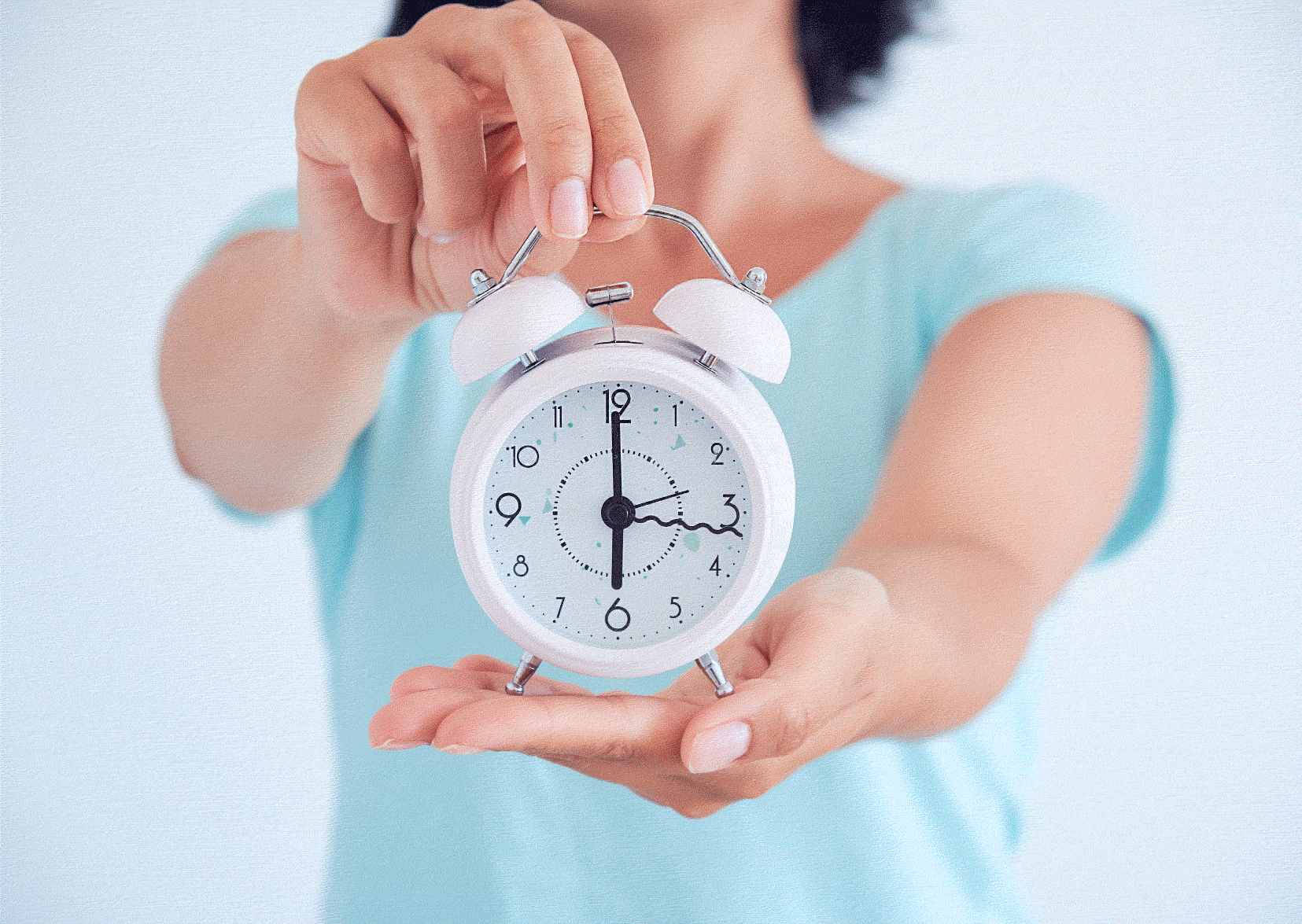 Nurse holding a clock