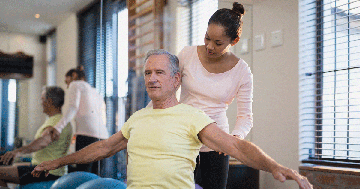 Physiotherapist stretching mans leg