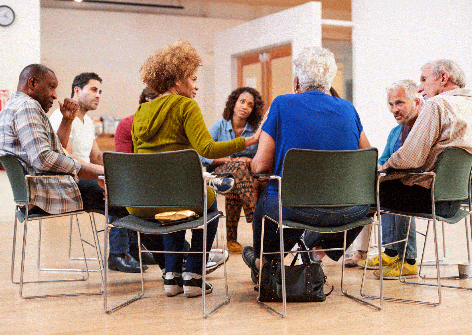 Group of elderly people sitting in a circle talking