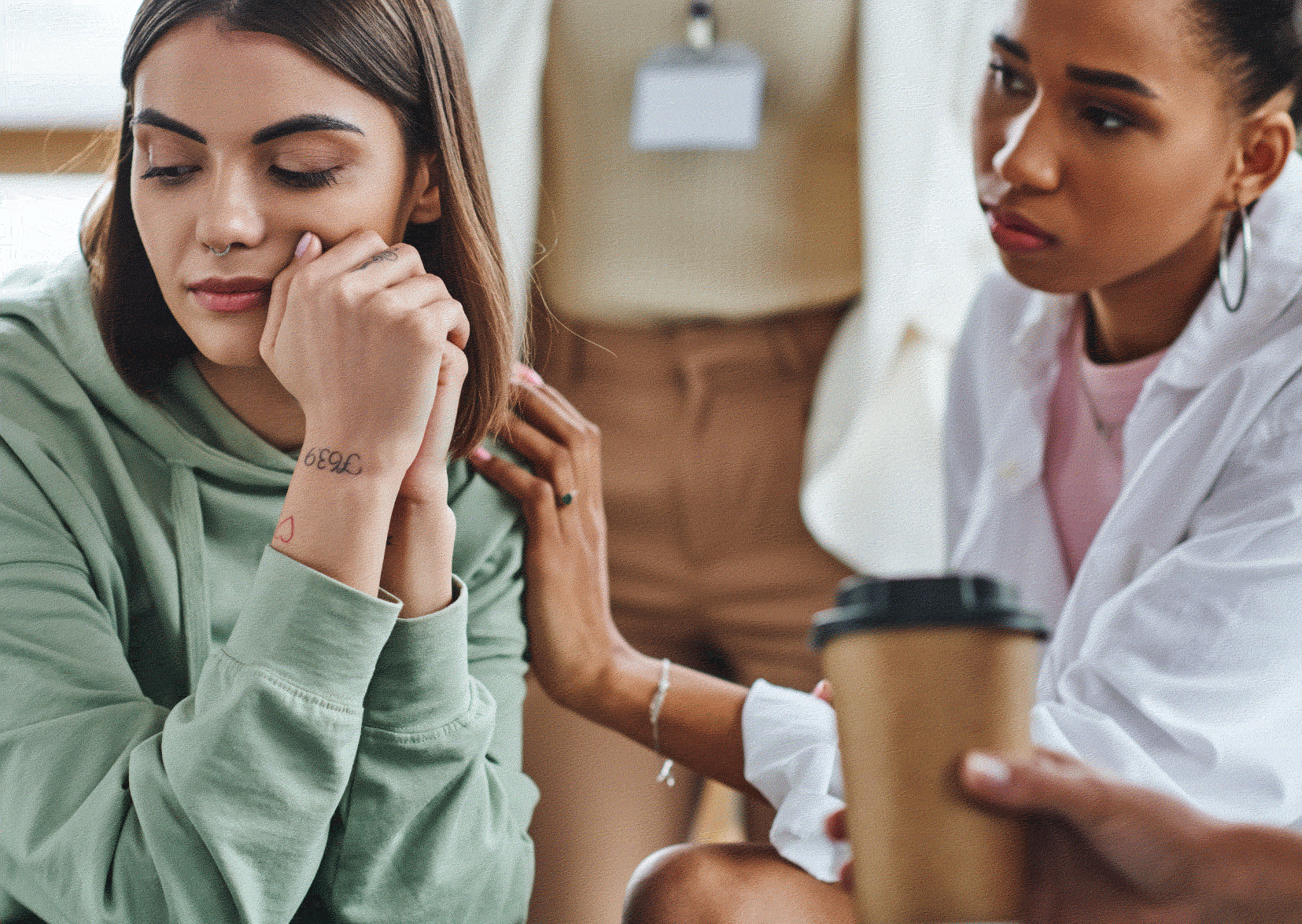 Social worker touching arm of substance misuse woman