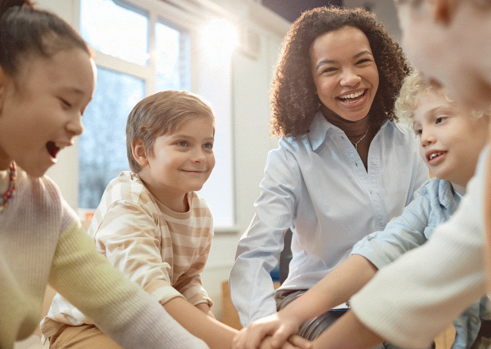 Smiling social worker with three smiling children