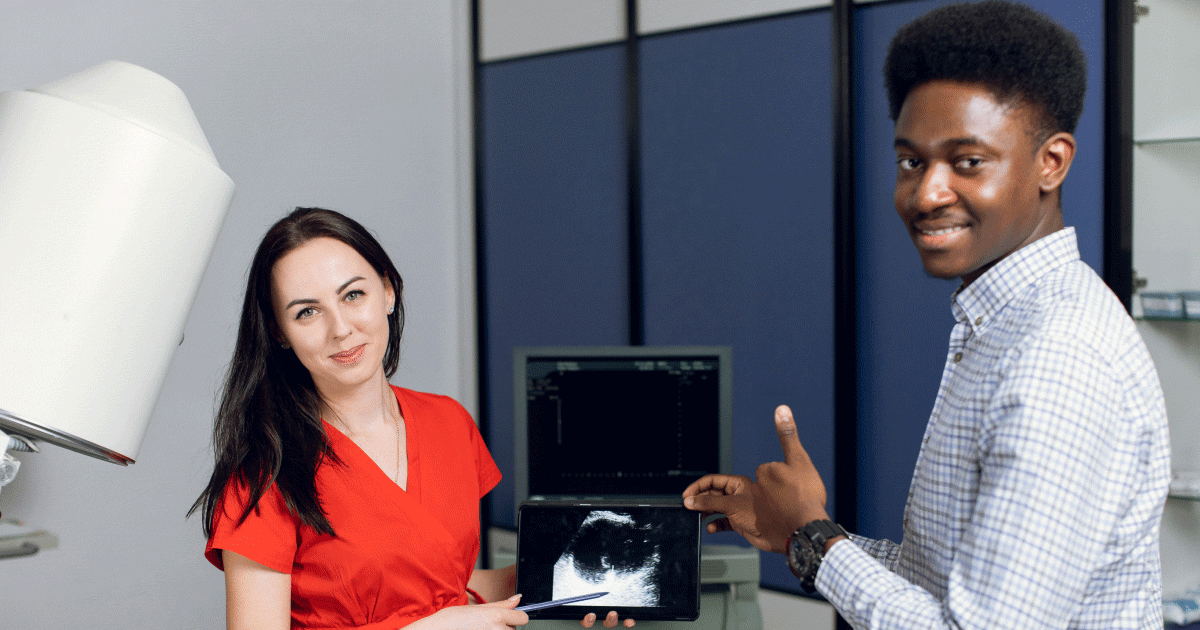 Student sonographer looking at scan