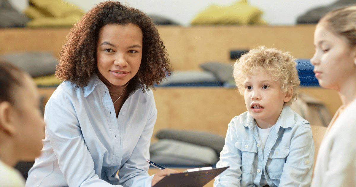 Speech and language therapy student with children